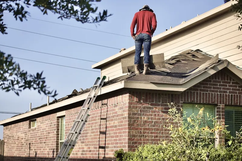 Professional roofer working on a residential roof in Sandy Spring Estates